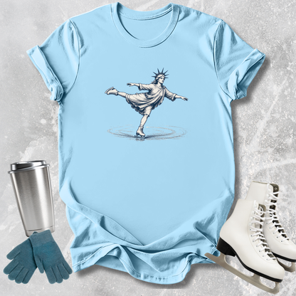 Light blue t-shirt with a graphic of the Statue of Liberty on a textured surface with accessories.