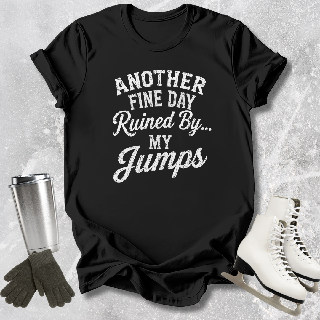 Black t-shirt with text 'Another fine day ruined by my jumps' on a textured surface with accessories.