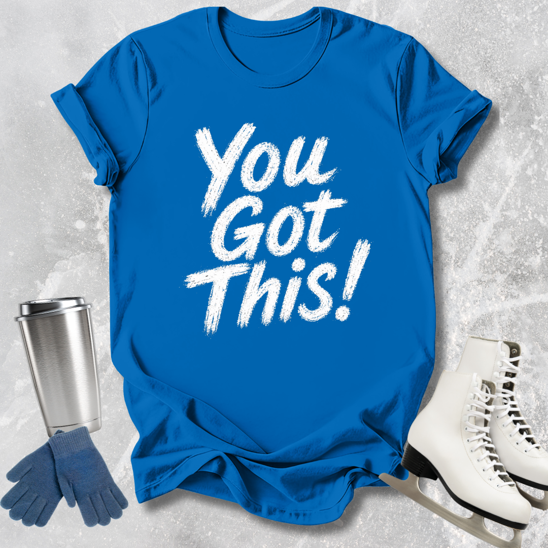 Blue t-shirt with 'You Got This!' text, silver tumbler, blue gloves, and white skates on a textured gray background