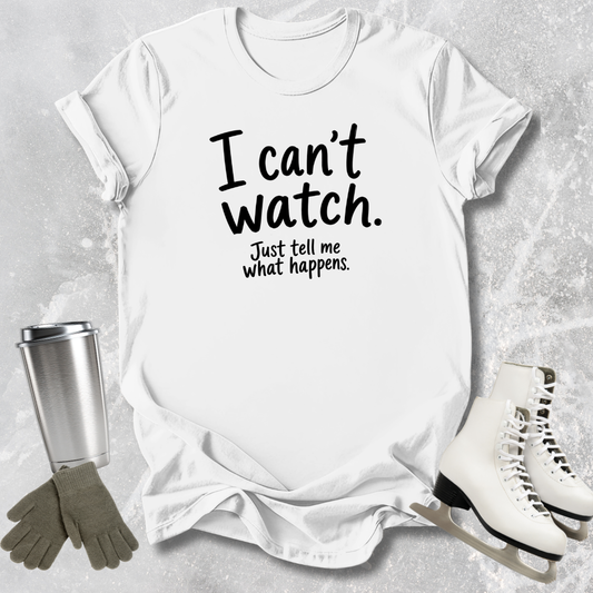 White t-shirt with text 'I can't watch. Just tell me what happens.' on a textured surface with accessories.