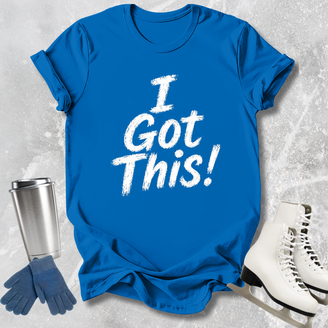 Blue t-shirt with 'I Got This!' text, silver tumbler, blue gloves, and white skates on a textured gray background