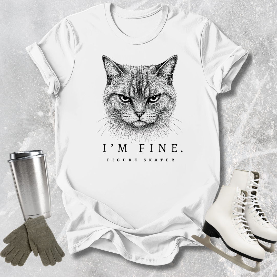 White t-shirt with a cat graphic and text, surrounded by a tumbler, gloves, and figure skates on a textured surface.