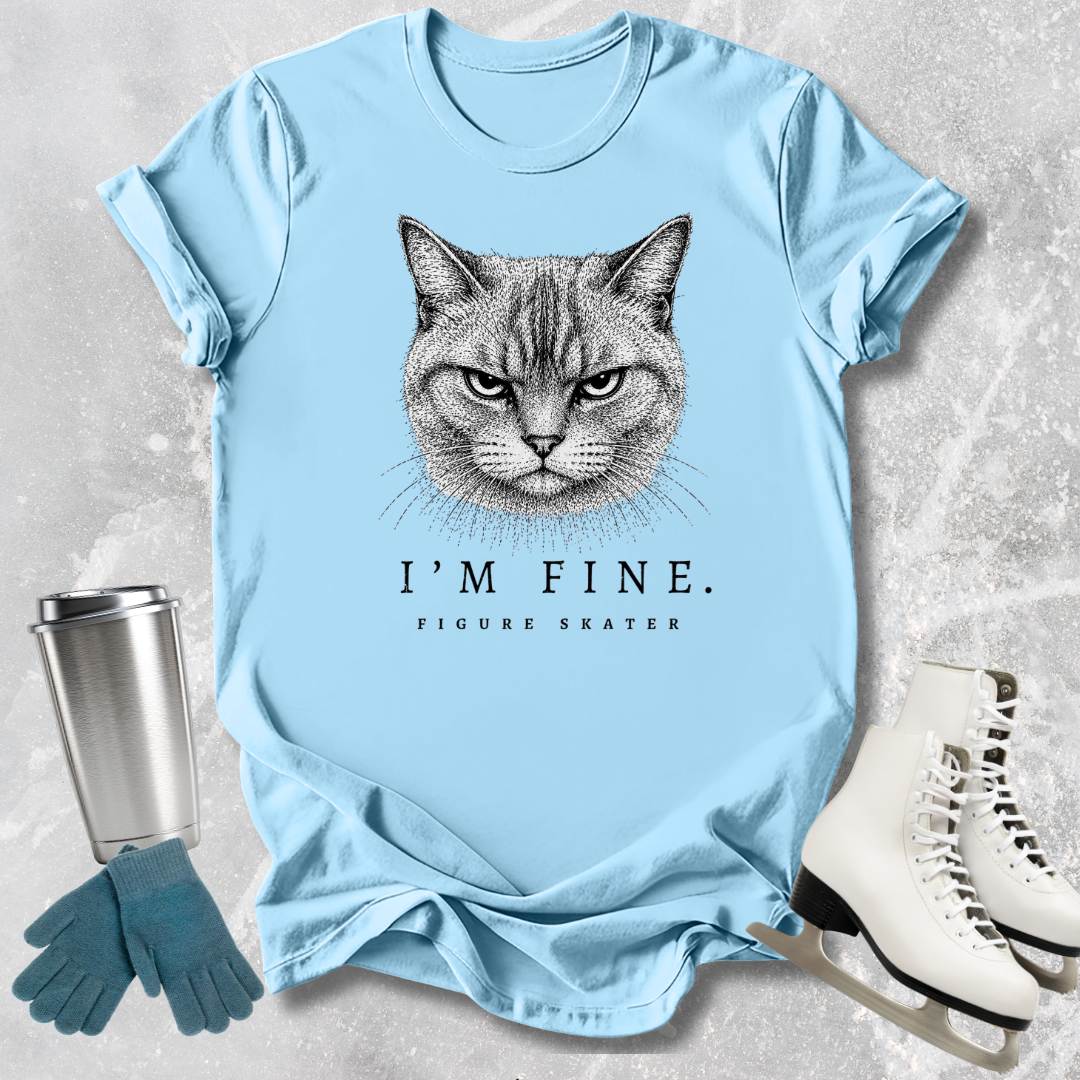 Light blue t-shirt with a cat graphic and text, placed on a textured surface with accessories.