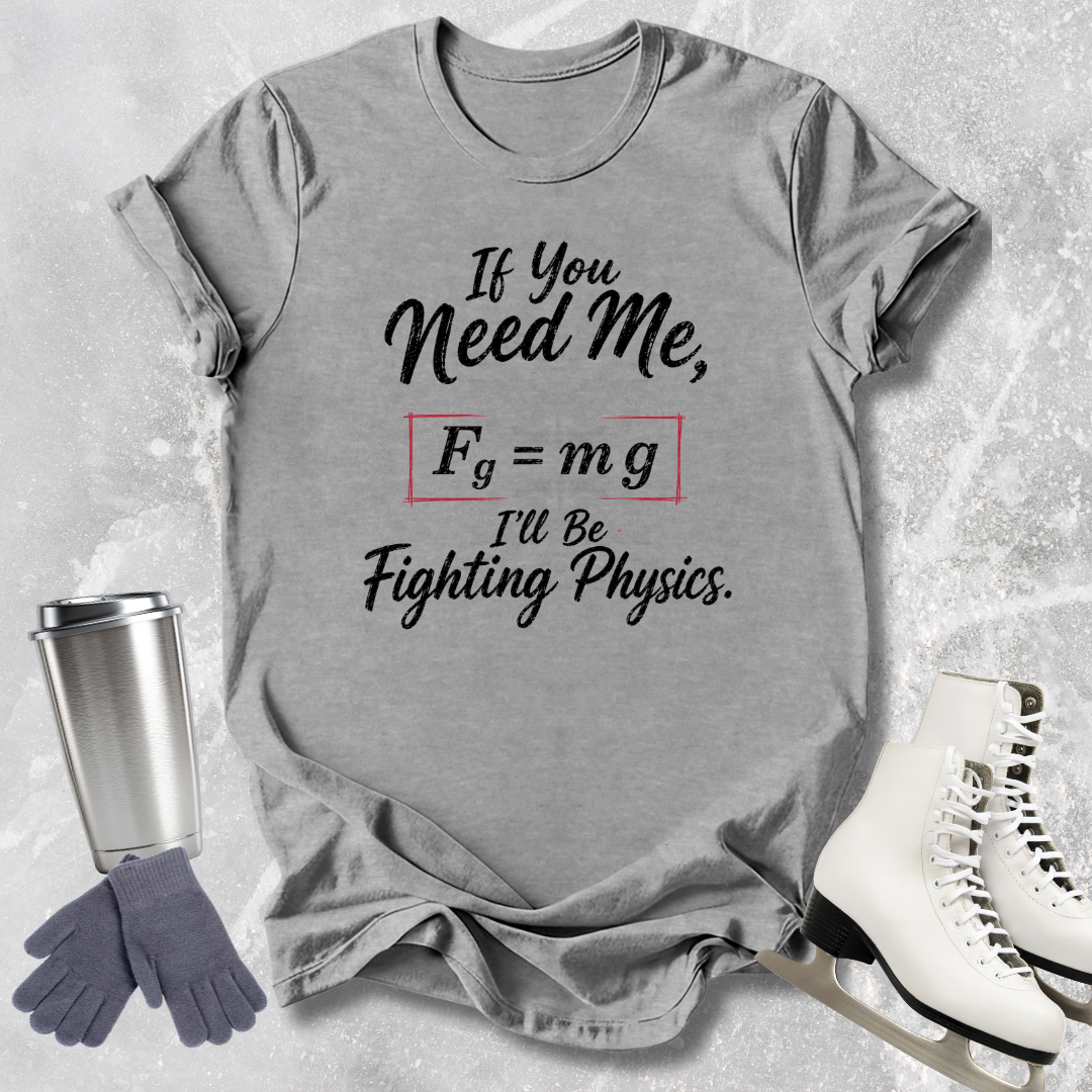 Gray t-shirt with humorous physics-themed text, next to a tumbler, gloves, and skates on a light gray background.