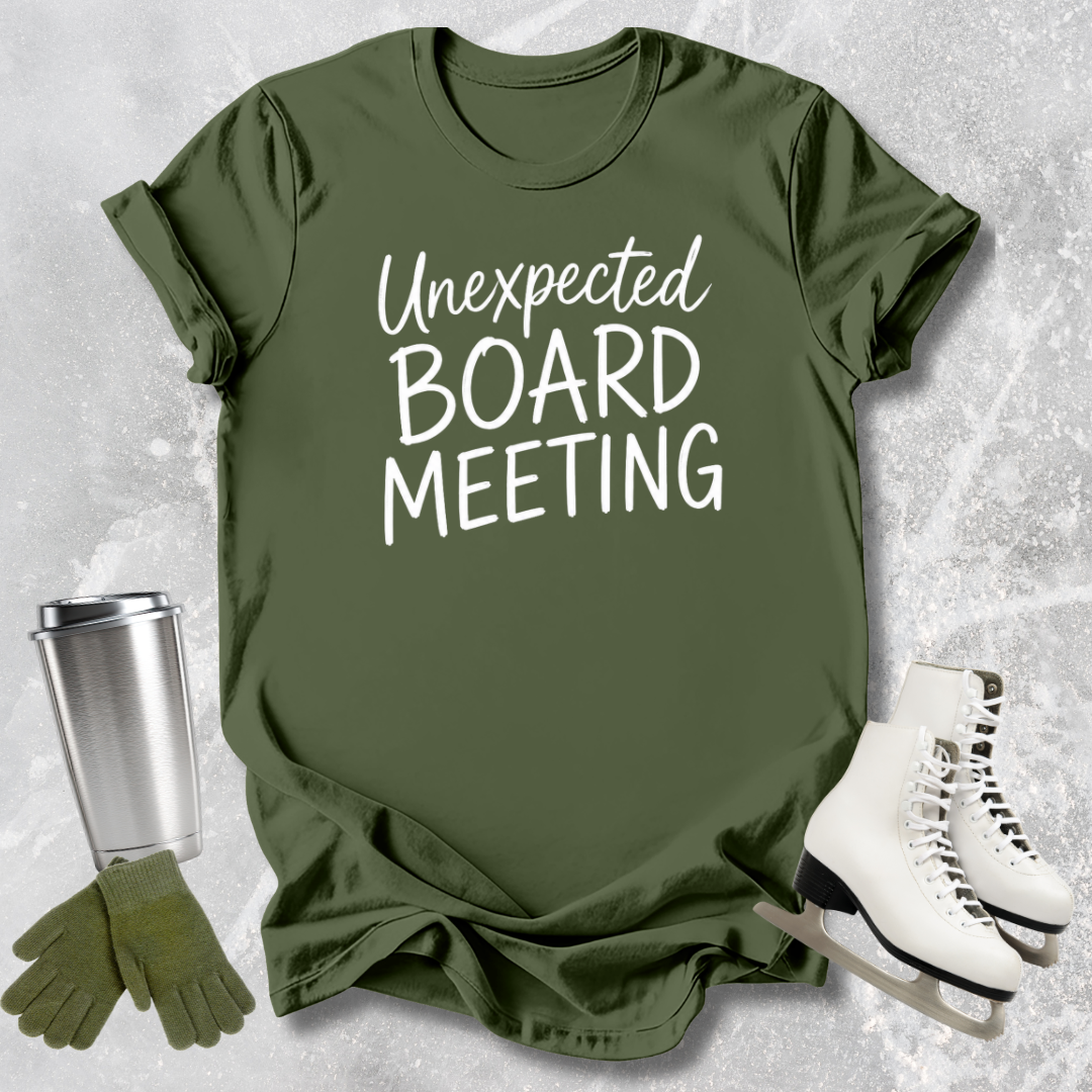 Green t-shirt with 'Unexpected Board Meeting' text, next to a silver tumbler, green gloves, and white skates on a textured gray background.