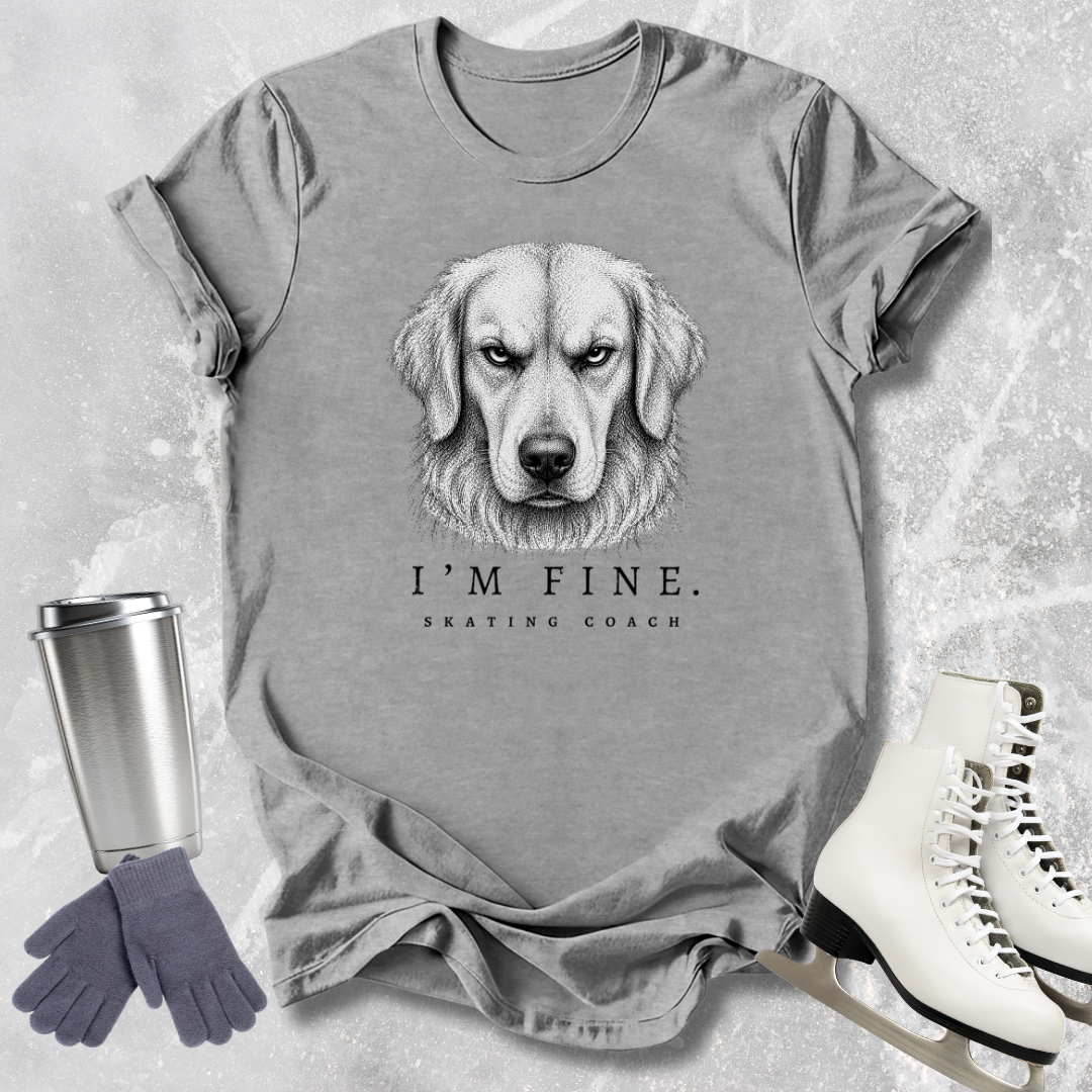 Gray t-shirt with a dog graphic and text, placed on a textured surface with a tumbler, gloves, and skates.