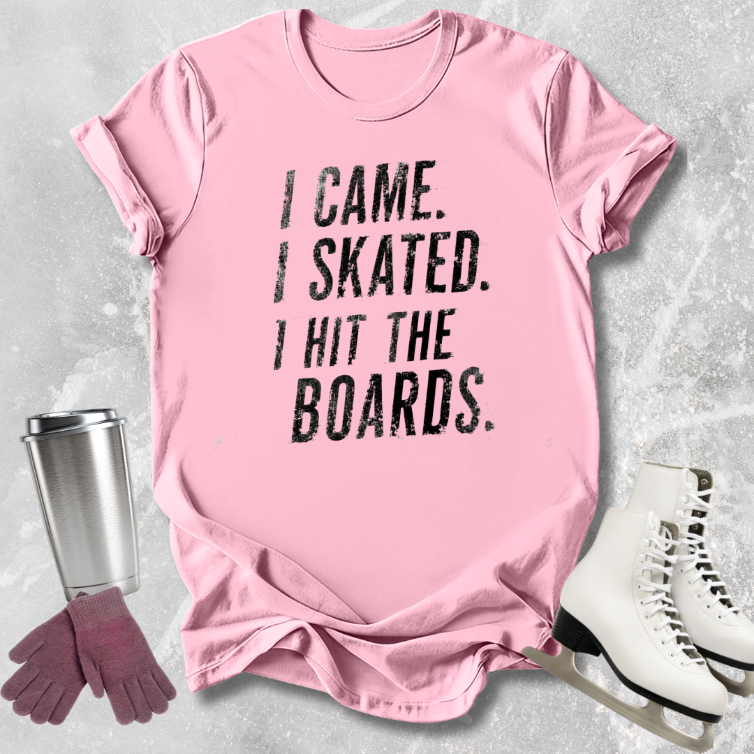 Pink t-shirt with 'I Came. I Skated. I Hit The Boards.' text, next to ice skates and a tumbler on a light gray background.