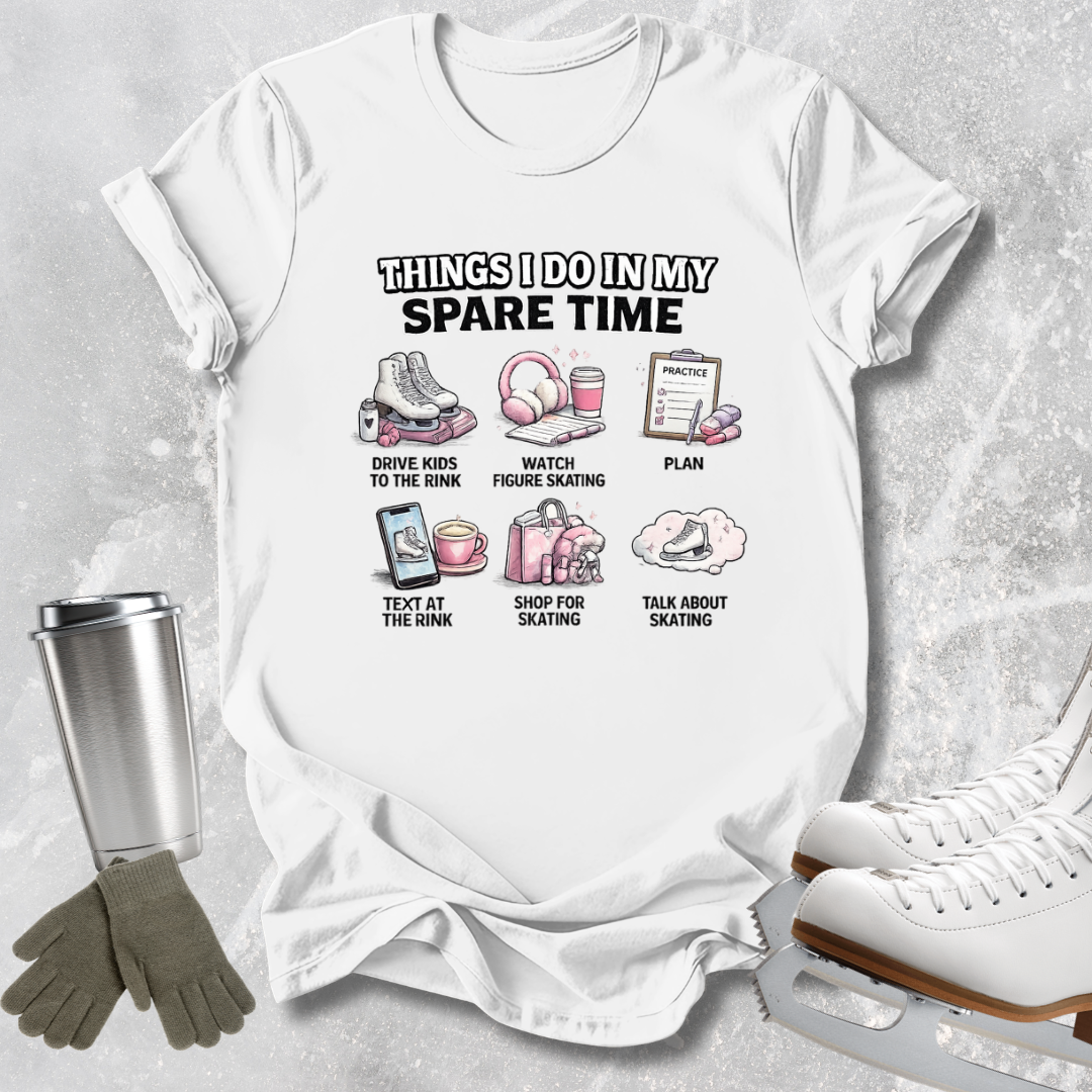 A white graphic t-shirt laid flat on a light gray textured background, surrounded by ice skating props including white ice skates, a silver tumbler, and a pair of gray gloves. The t-shirt features a black and pink graphic with the text 'THINGS I DO IN MY SPARE TIME' and six small illustrations with labels related to ice skating.