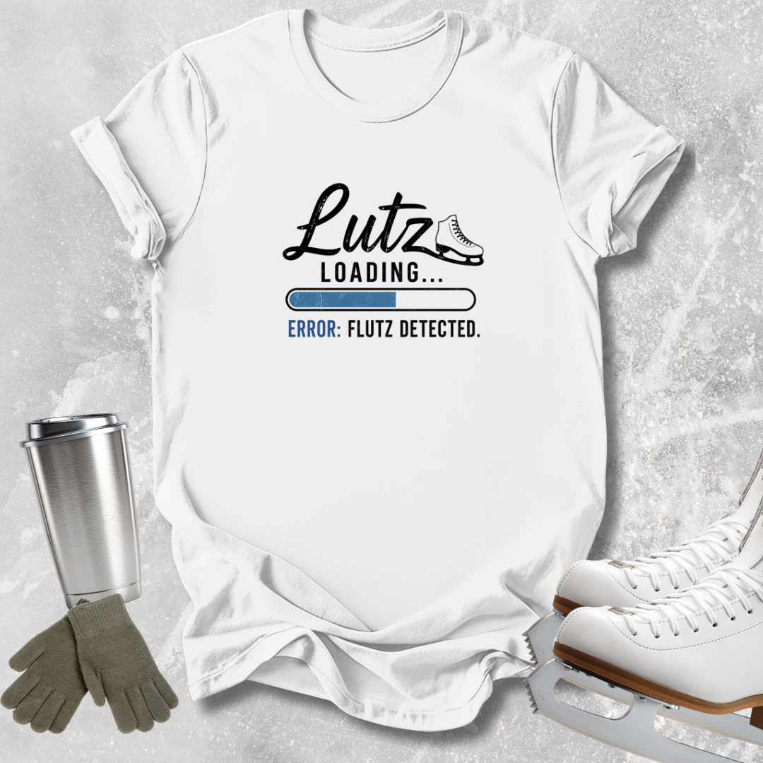 A white graphic T-shirt laid flat on a light gray textured surface, with a printed design reading 'Lutz Loading.