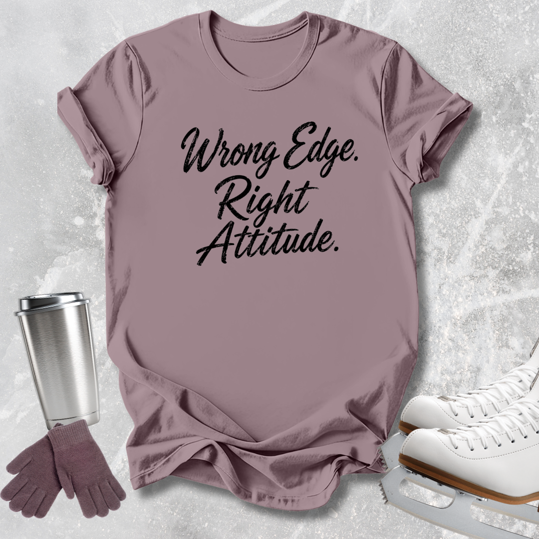 A mauve short-sleeve graphic T-shirt laid flat on a light gray textured surface, with the phrase 'Wrong Edge. Right Attitude.