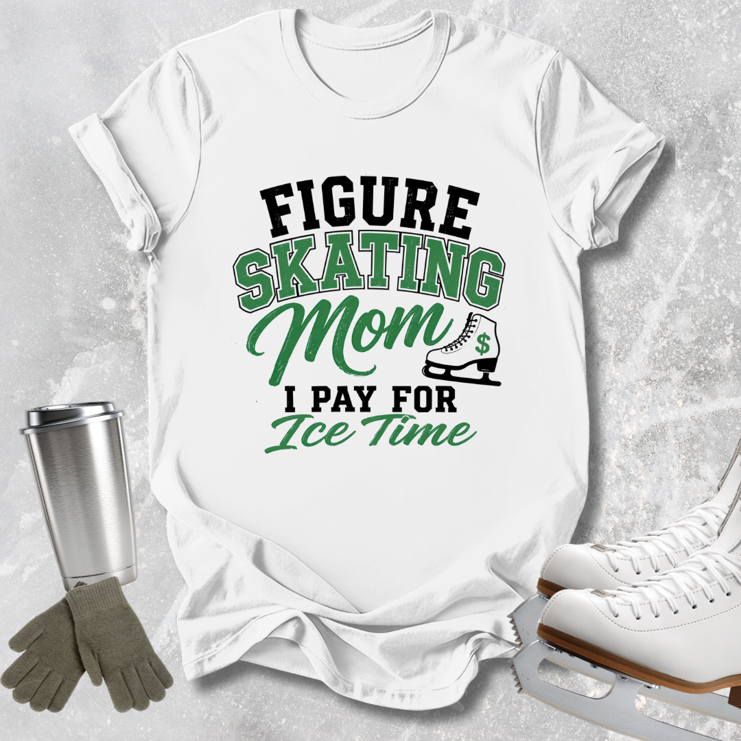 A white graphic t-shirt featuring the text 'FIGURE SKATING Mom I PAY FOR Ice Time' in black and green lettering, styled in a flat-lay arrangement with ice skates, gloves, and a metal tumbler on a textured gray background.