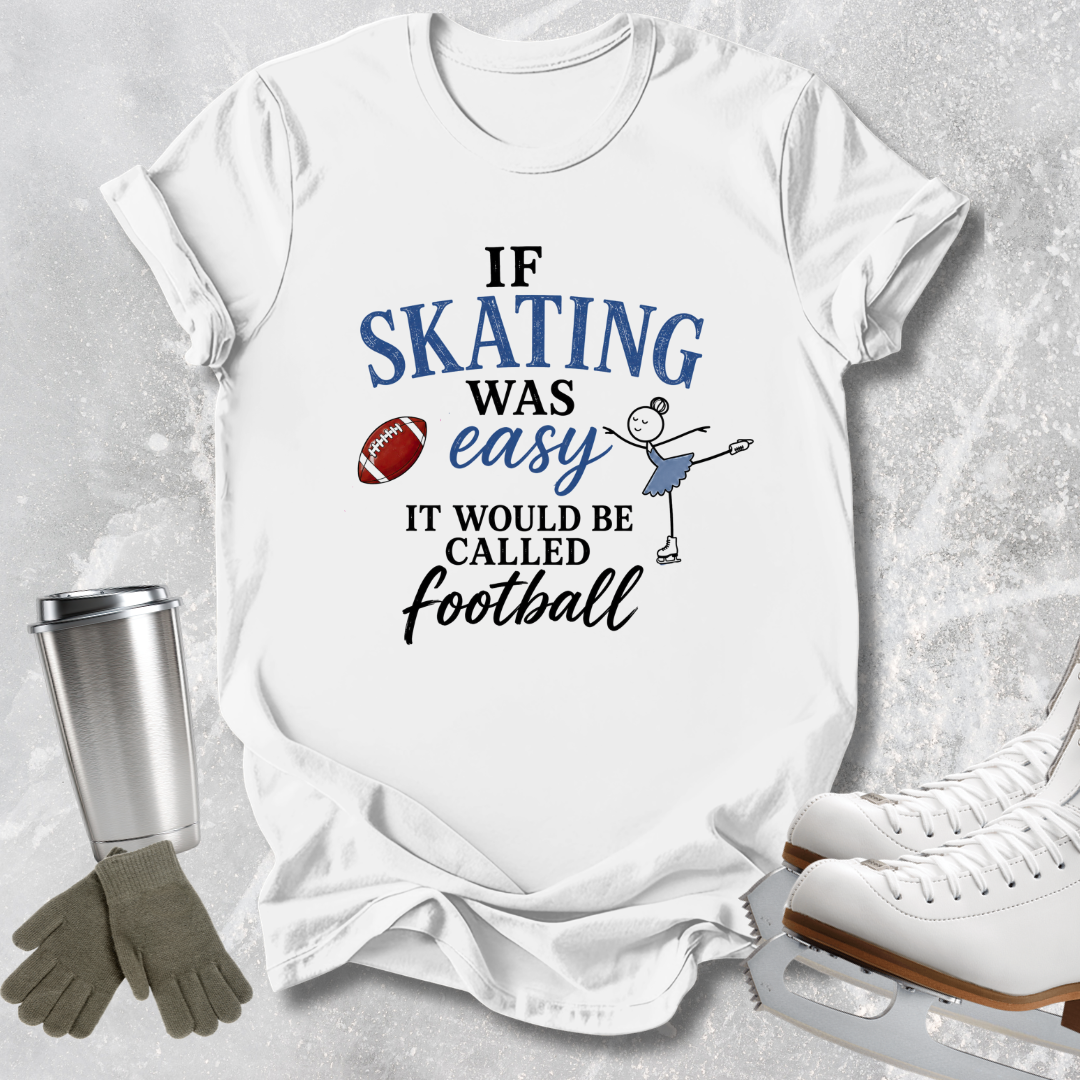A white graphic T-shirt laid flat on a light gray textured surface, with a printed slogan reading 'IF SKATING WAS easy IT WOULD BE CALLED Football' in blue and black lettering, plus a small skater illustration and football icon. Surrounding props include ice skates, gloves, and a metal cup.