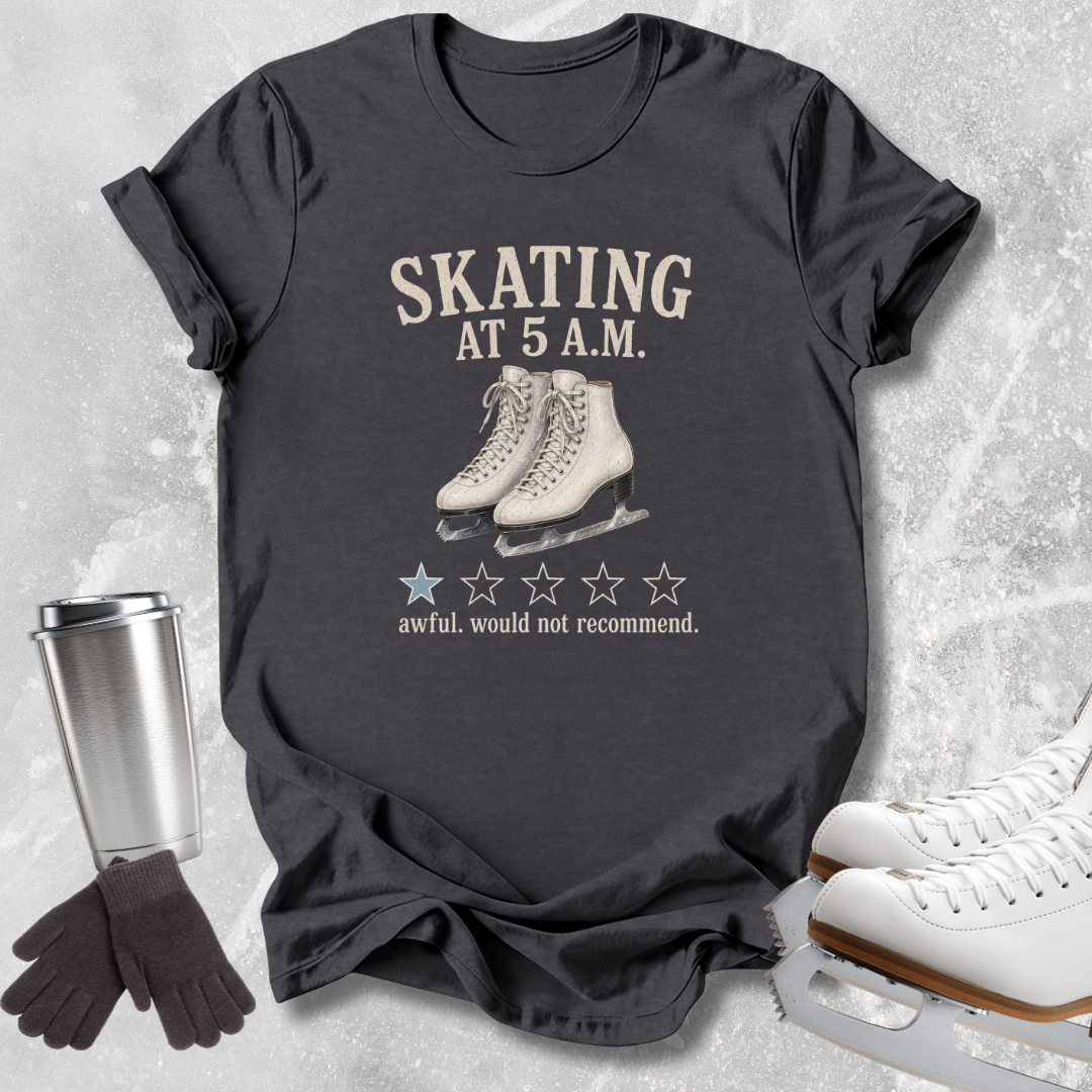 A dark charcoal gray graphic t-shirt featuring a vintage-style print of ice skates and the text 'SKATING AT 5 A.M.