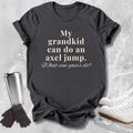 A dark charcoal gray graphic t-shirt with the text 'My grandkid can do an axel jump. What can yours do?' printed in cream.