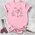 A pink short-sleeve graphic T-shirt laid flat on a light gray textured surface, with a black line drawing of an ice skater and labeled callouts. A stainless steel tumbler, purple gloves, and white ice skates are placed around it as styling props.