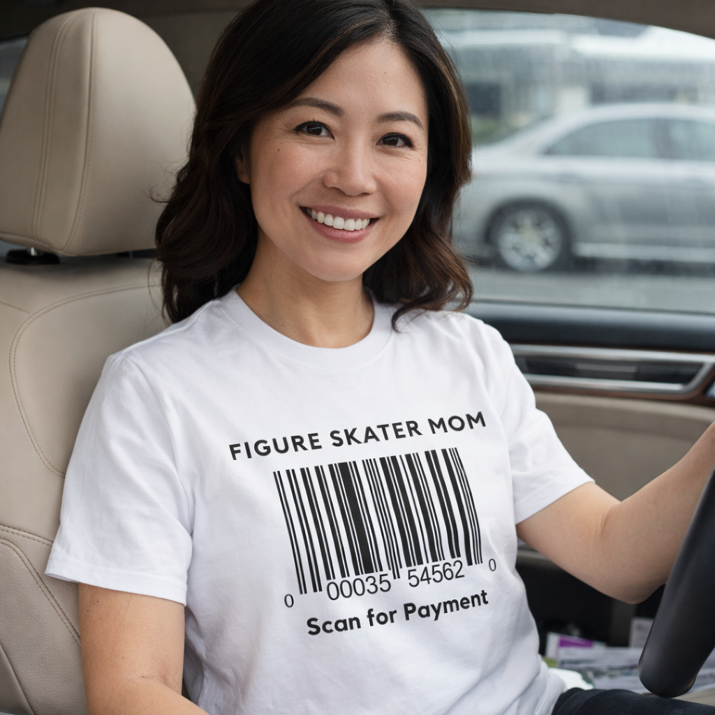 Woman sitting in a car wearing a white t-shirt with a barcode design and text.