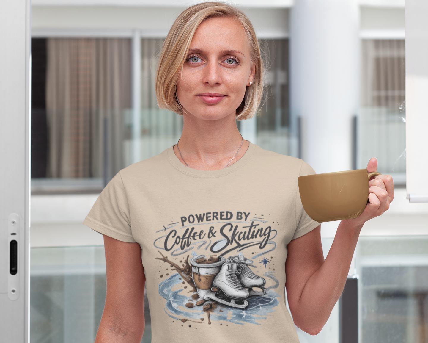 Woman wearing a t-shirt with 'Powered by Coffee & Skating' design, holding a mug.